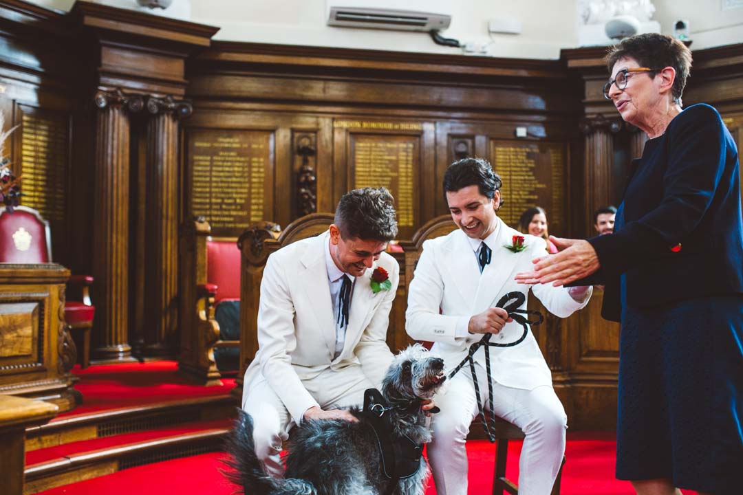 two grooms with their dog