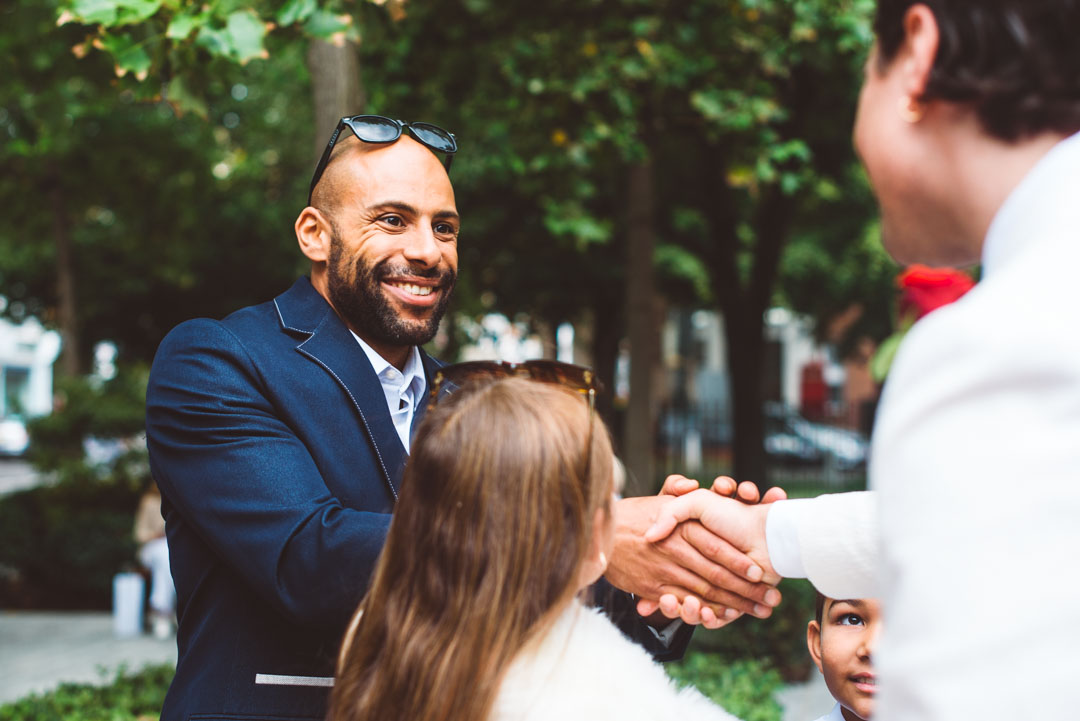 guest congratulating groom
