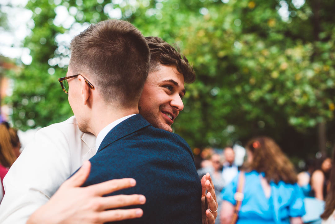 groom and friend hugging