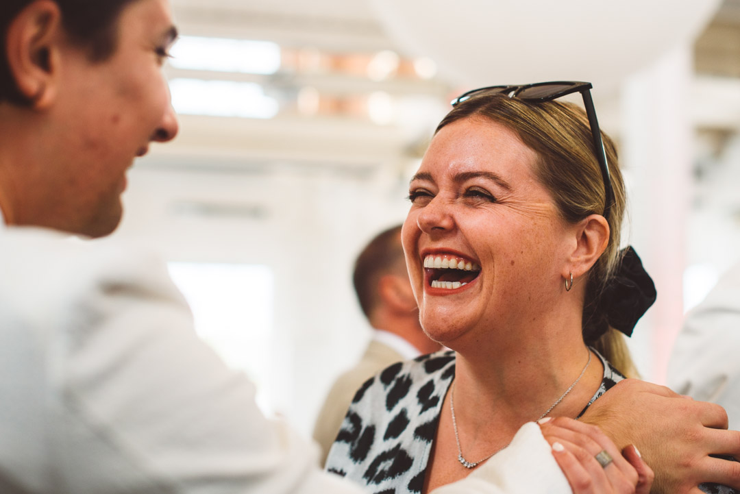 candid wedding photo laughing guest