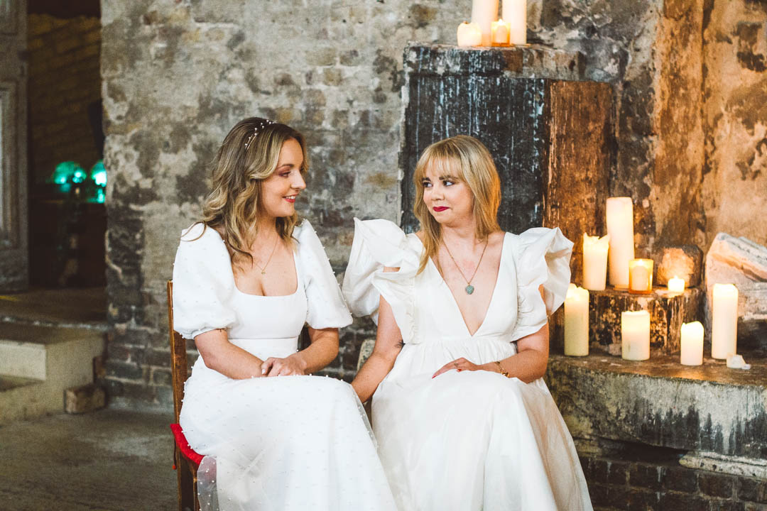 Asylum Chapel lesbian wedding brides looking at each other