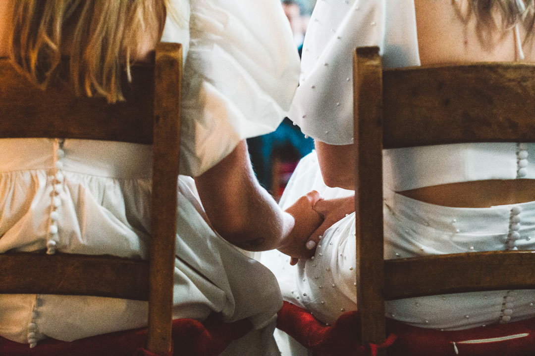 Asylum Chapel lesbian wedding brides holding hands