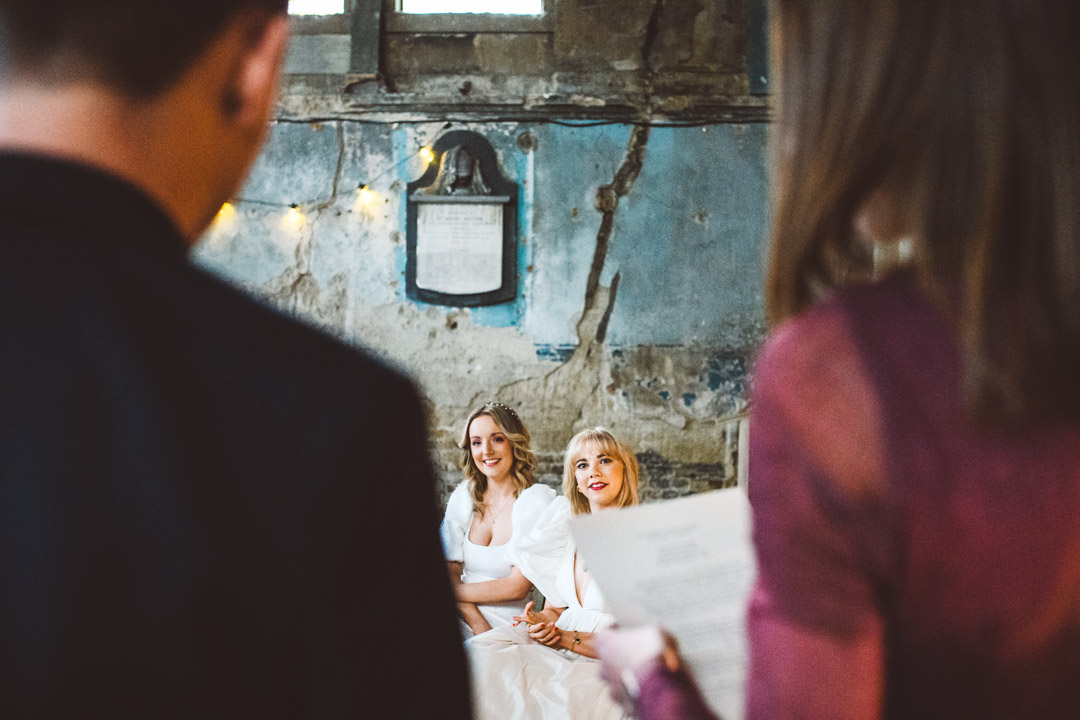 Asylum Chapel lesbian wedding brides listening to reading