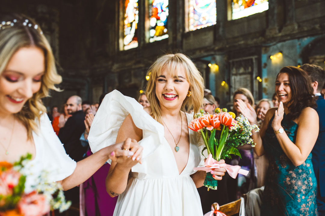 Asylum Chapel lesbian wedding newlyweds walking out