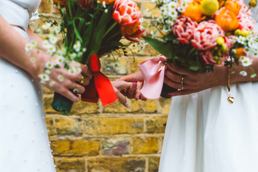 Asylum Chapel lesbian wedding brides holding hands