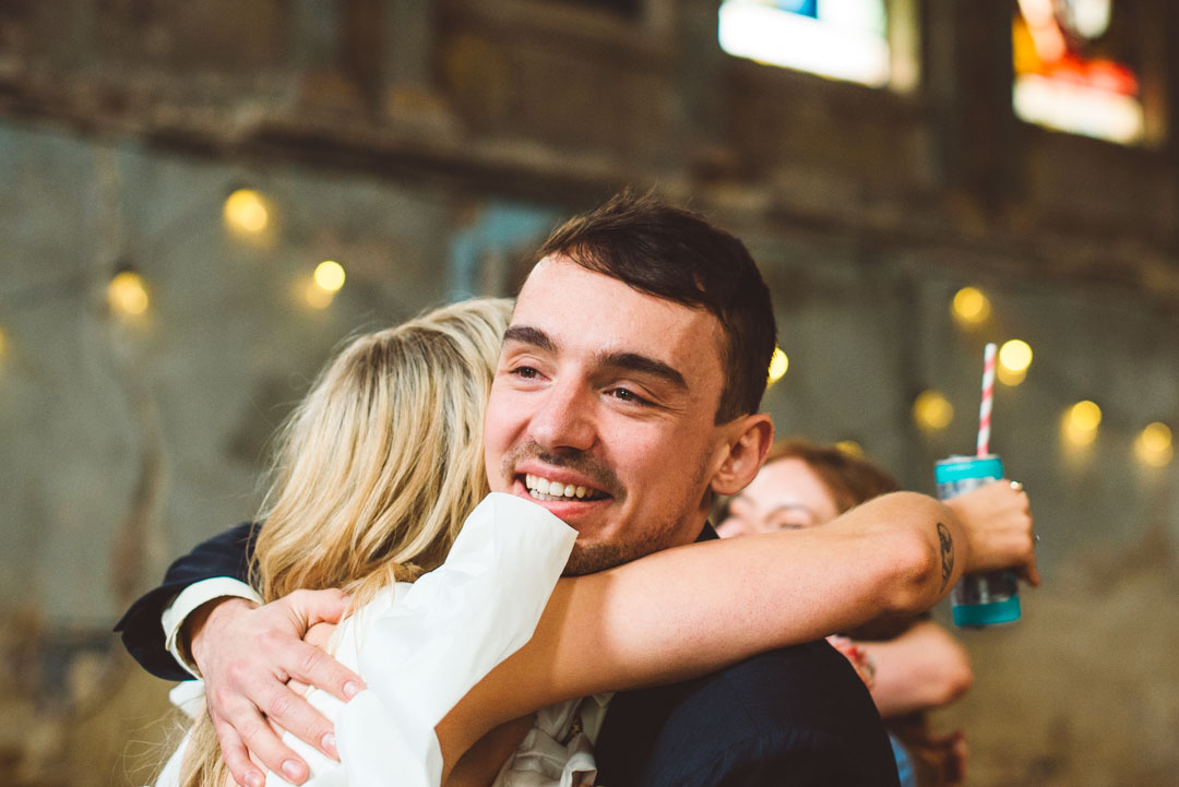 guest hugging bride