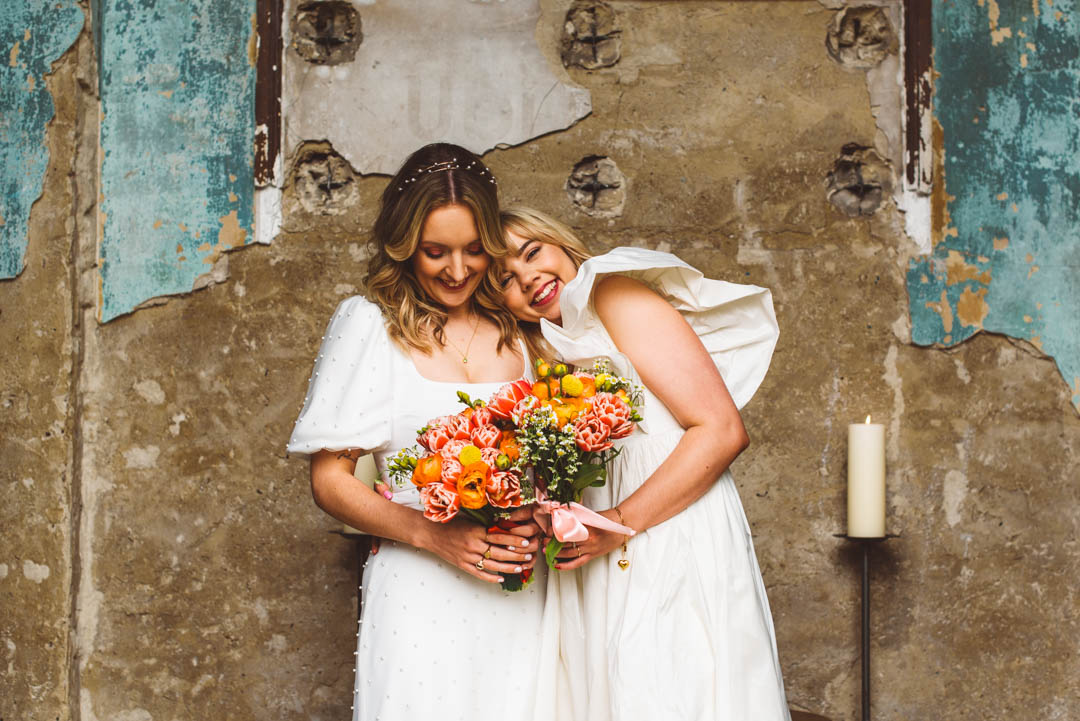Asylum Chapel lesbian wedding relaxed couple photo