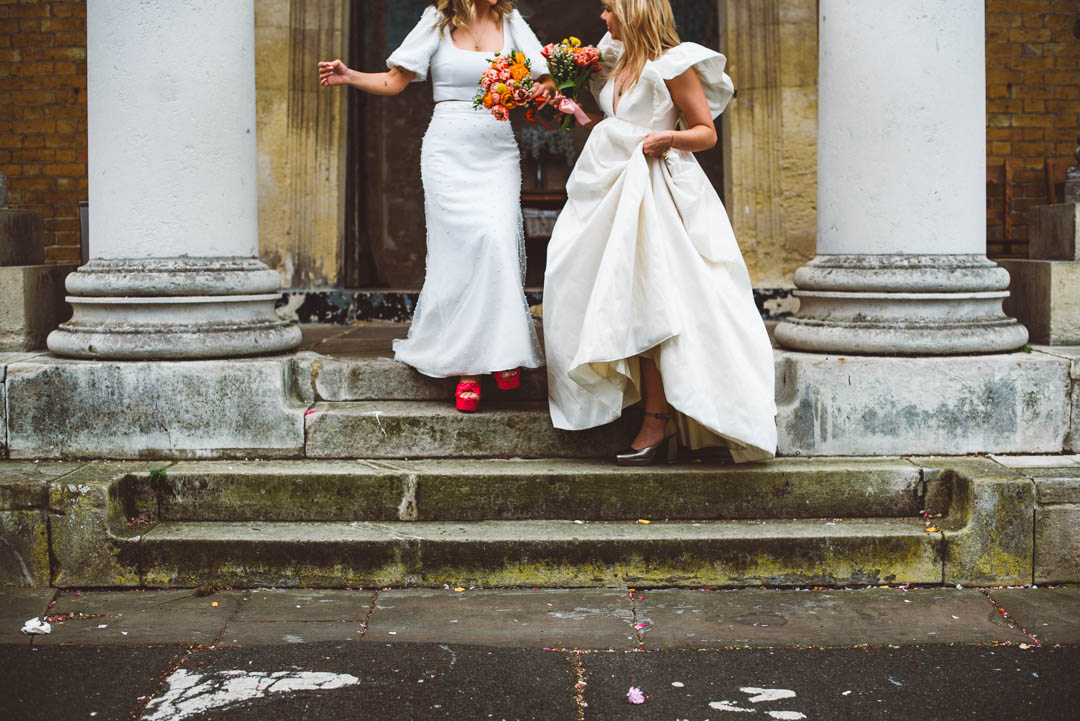 Asylum Chapel lesbian wedding brides on steps