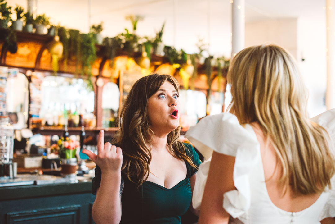 candid photo of guest chatting with bride