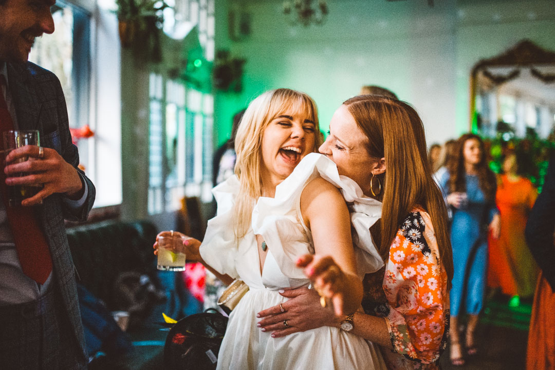 bride and friend laughing