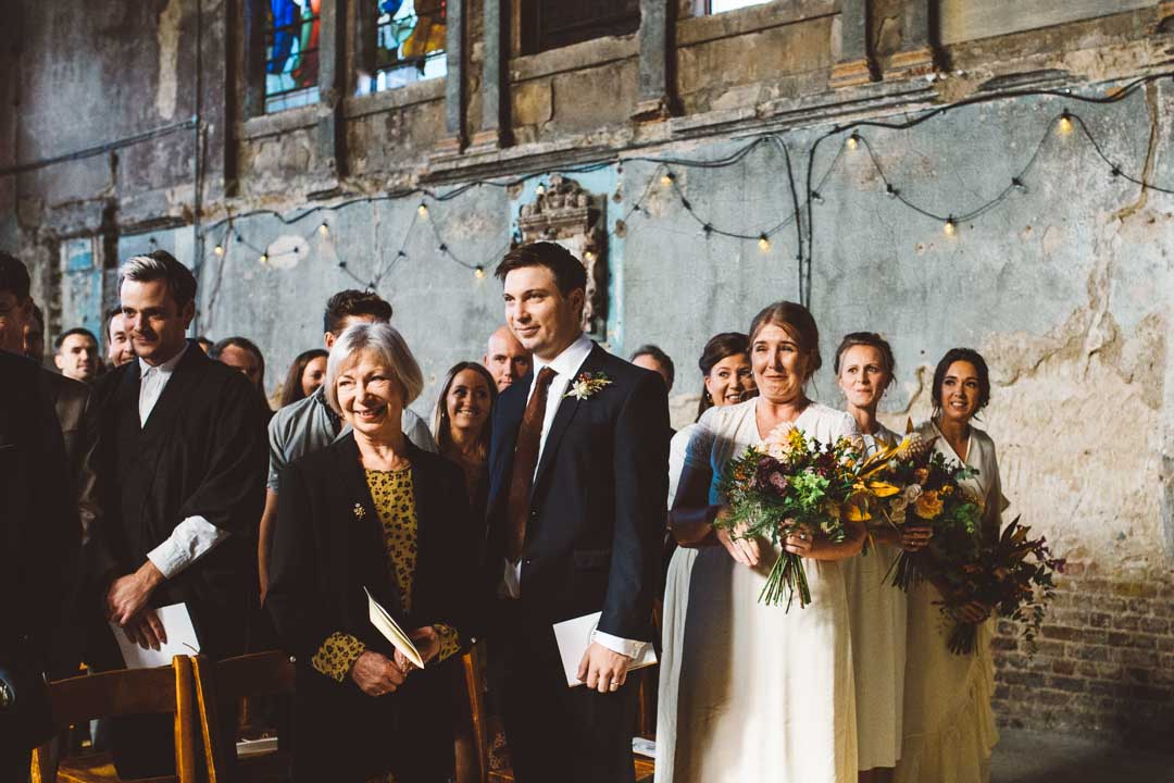 guests looking at bride