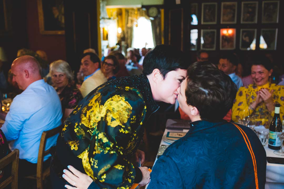 two brides kissing