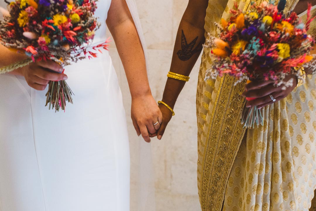 two brides holding hands