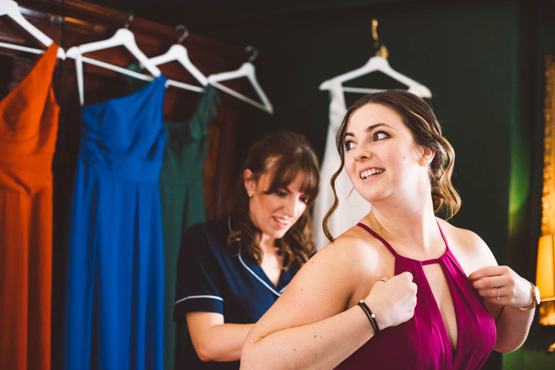 bridesmaid getting her dress on