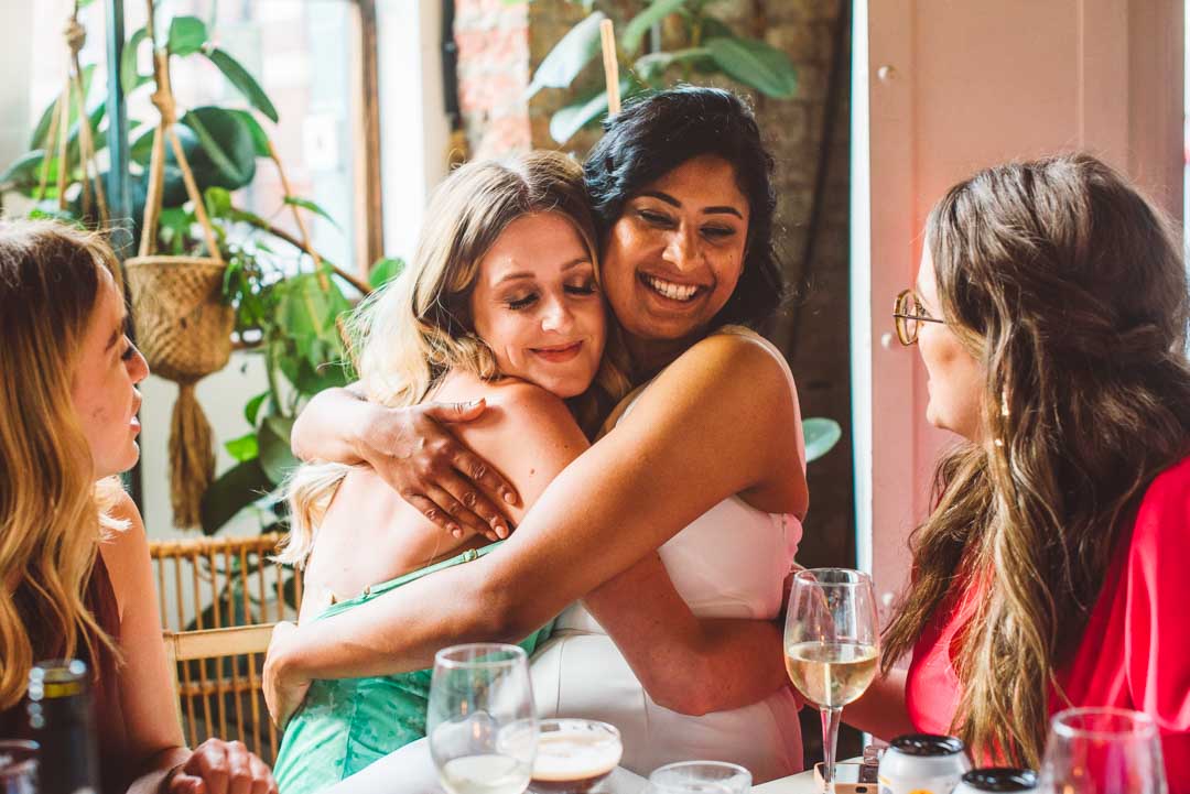 bride and friend hugging