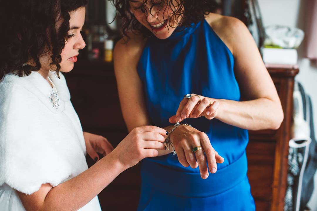 lesbian bride getting ready with bridesmaid