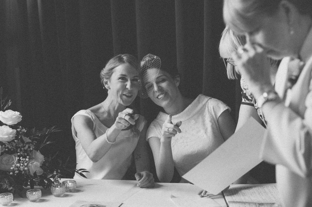 two brides signing register