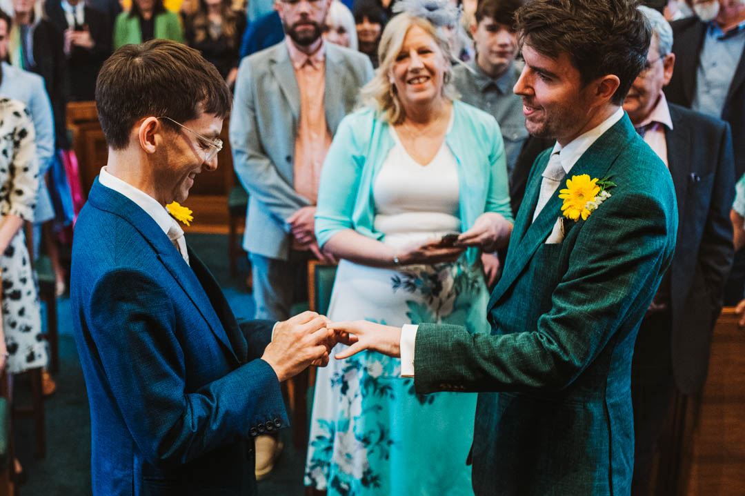 council chamber gay wedding exchanging rings