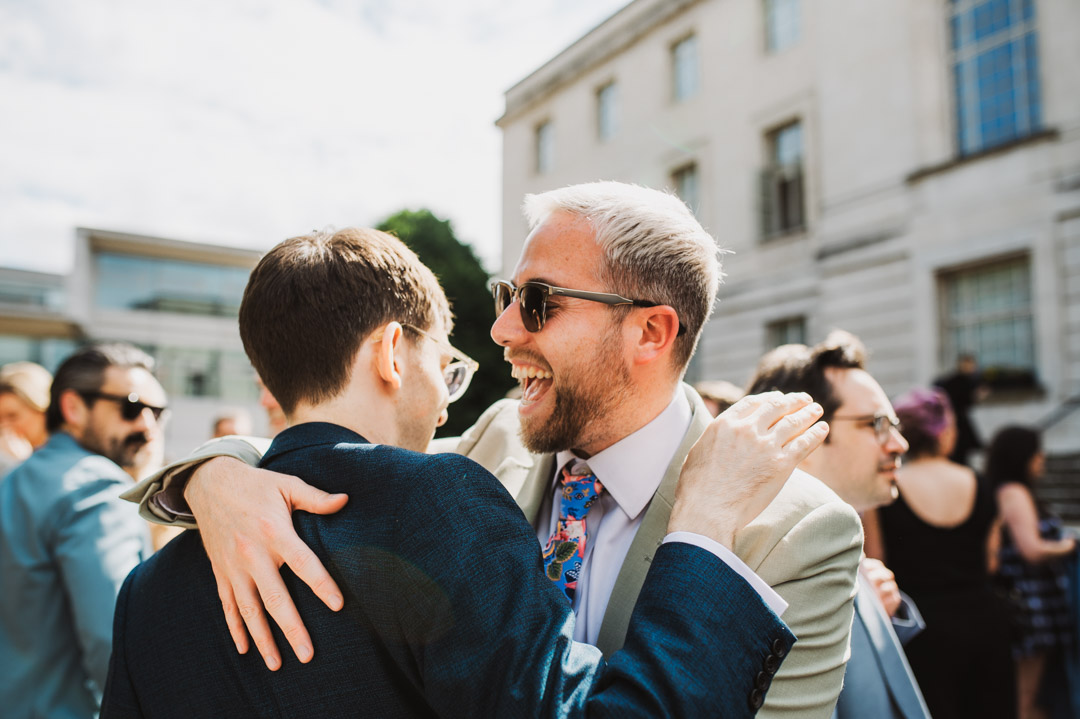 guest congratulating groom