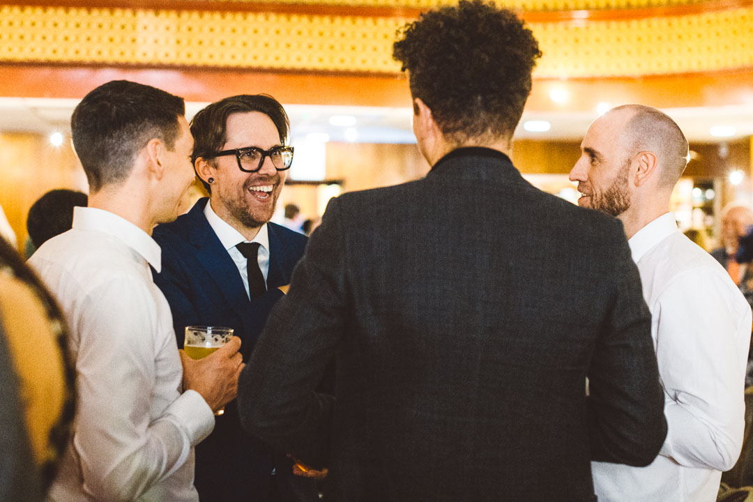 Candid wedding photography guests chatting