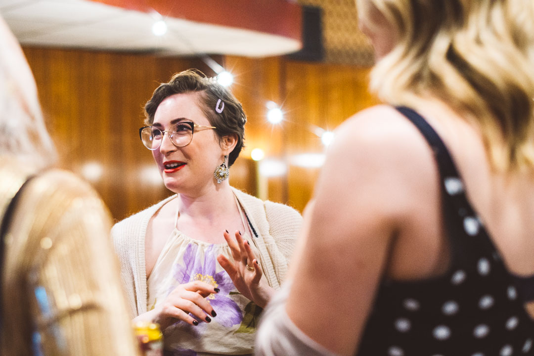 Candid wedding photographer guest chatting