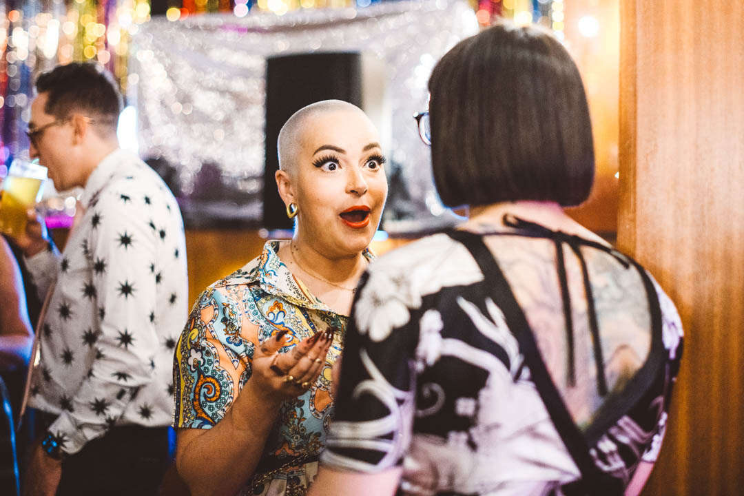 Candid wedding photo guest chatting