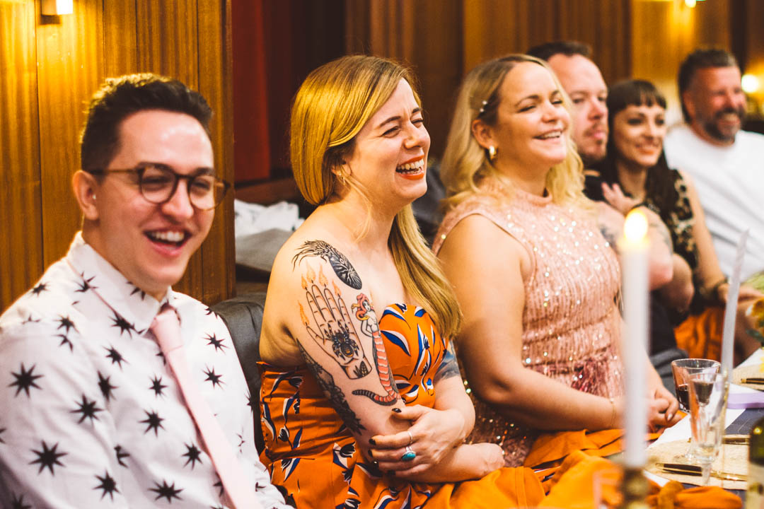 candid wedding photos guests laughing