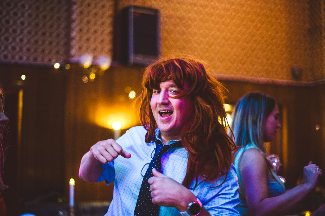 fun wedding photography guest wearing long hair wig