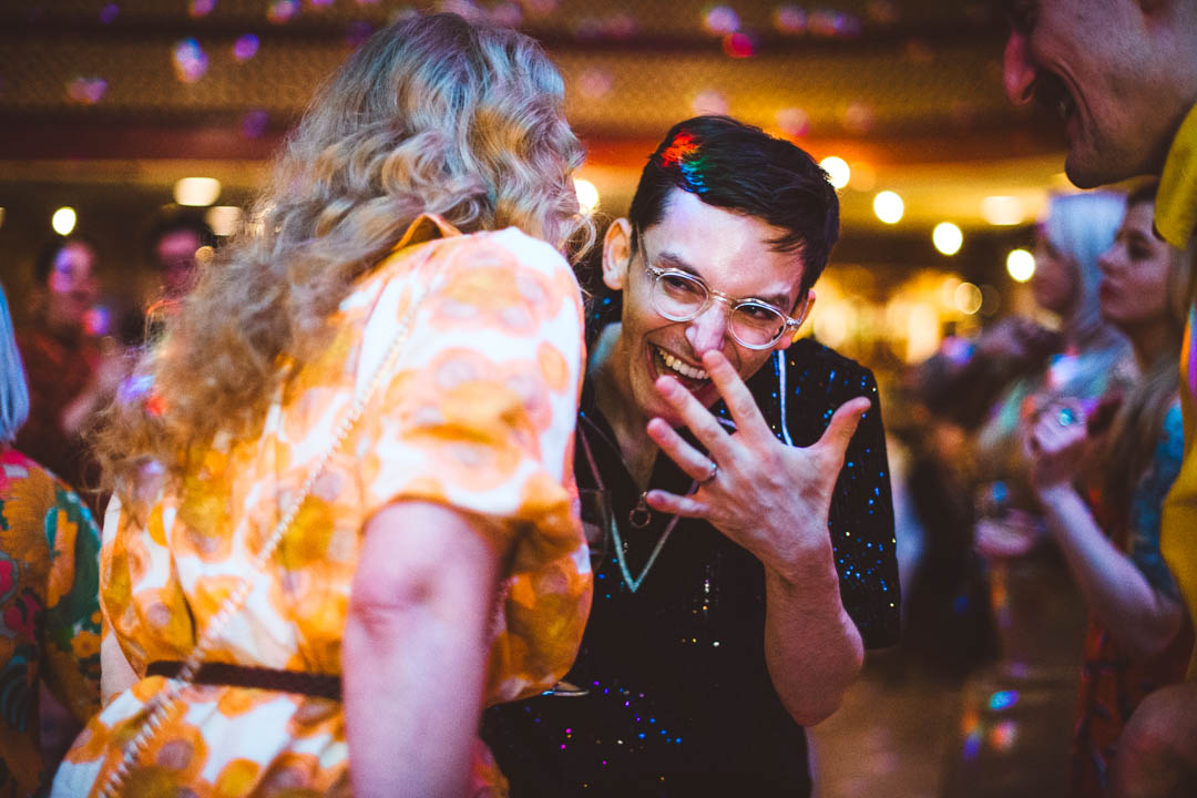 fun wedding photography groom laughing on dancefloor