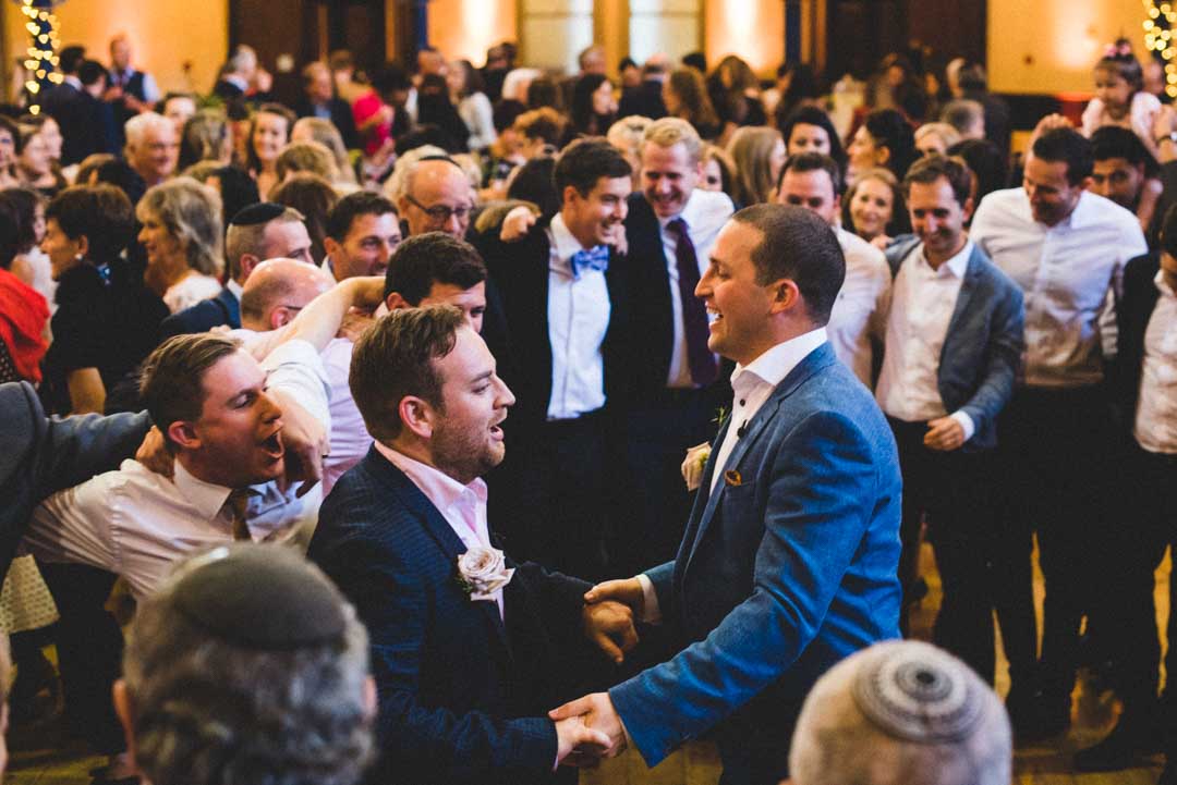 two grooms dancing