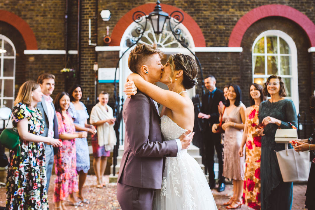 two brides kissing in front of Southwark Register Office