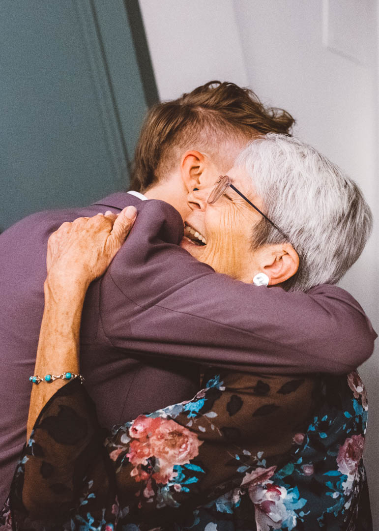 mother and bride hugging