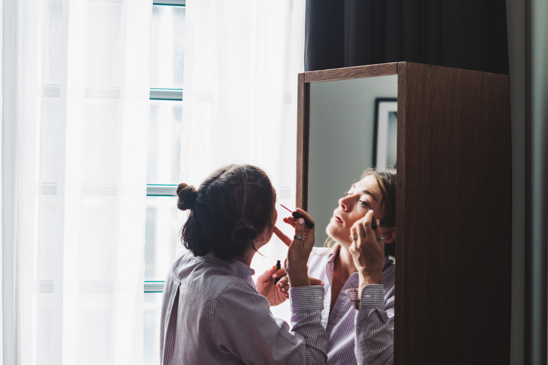 bridesmaid doing her make up