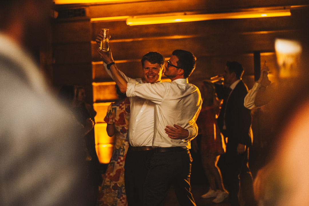 groom and friend dancing together