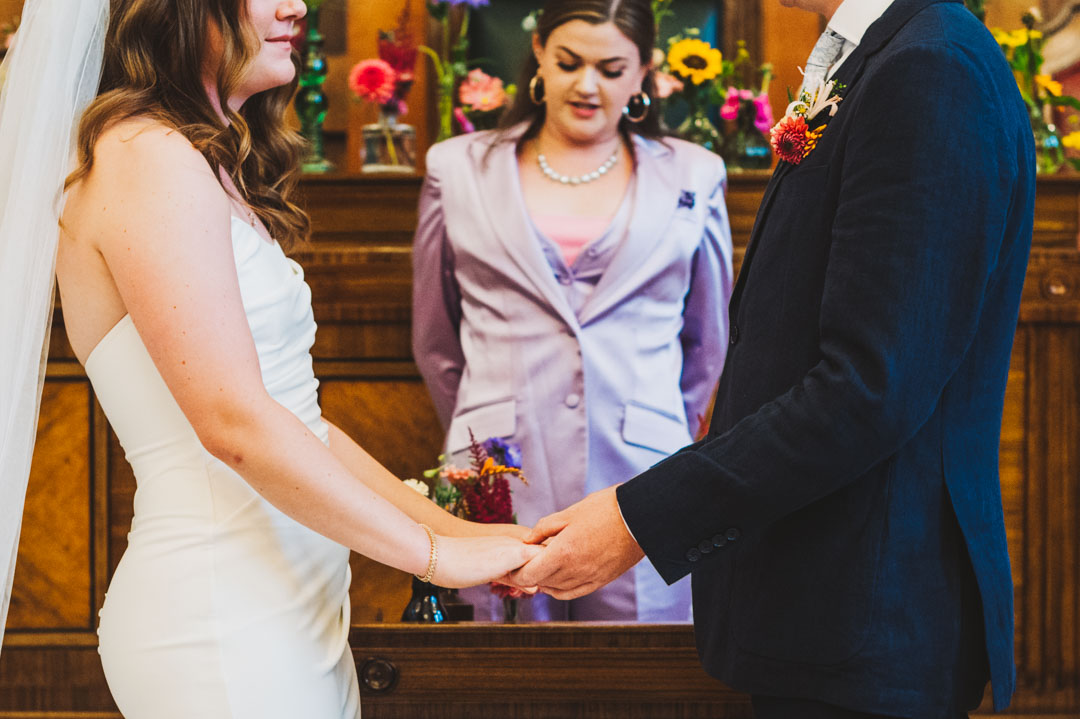 Town Hall Hotel Wedding close up bride and groom holding hands