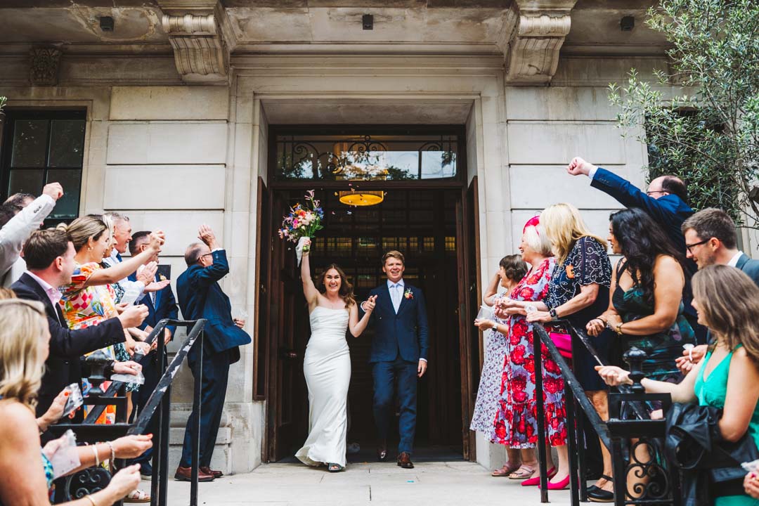 newlyweds walking out of Town Hall Hotel