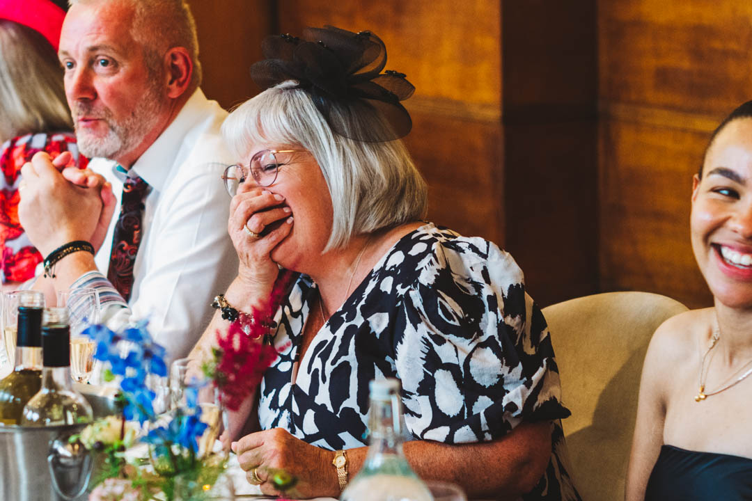 wedding reception female guest laughing