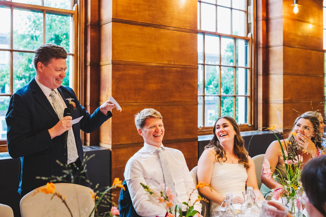 couple laughing at best man speech