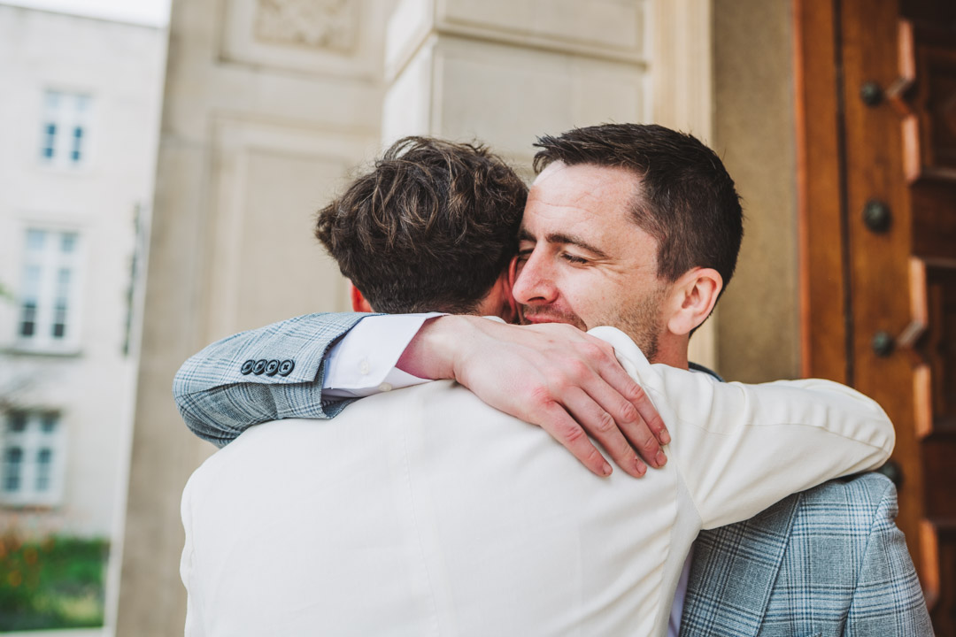 friend congratulating groom