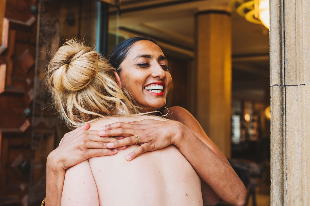 Waltham Forest Town Hall wedding friend hugging bride