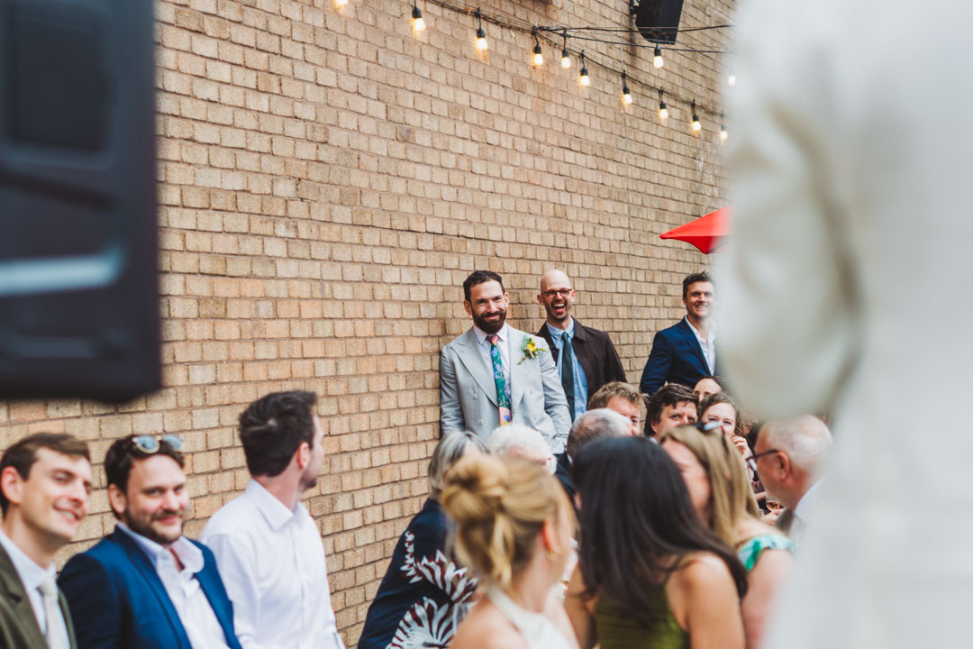 bestman listening to groom's speech