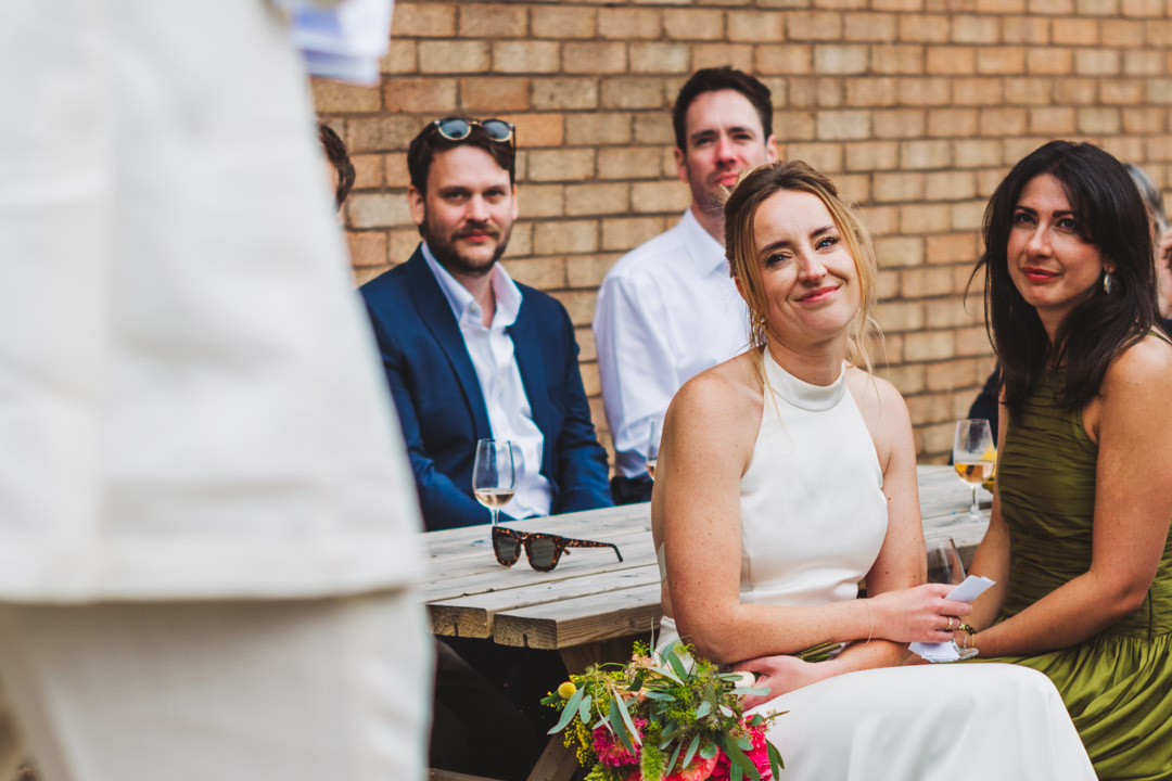 Renegade Urban Winery wedding bride listening to groom's speech