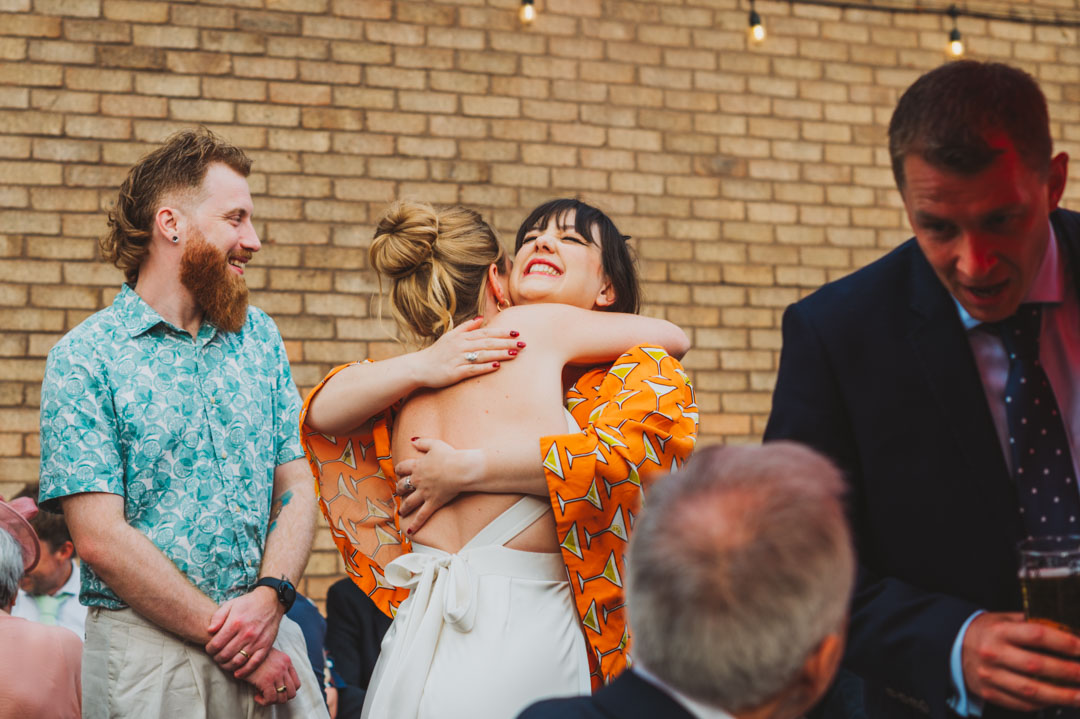 Renegade Urban Winery wedding bride and friend hugging