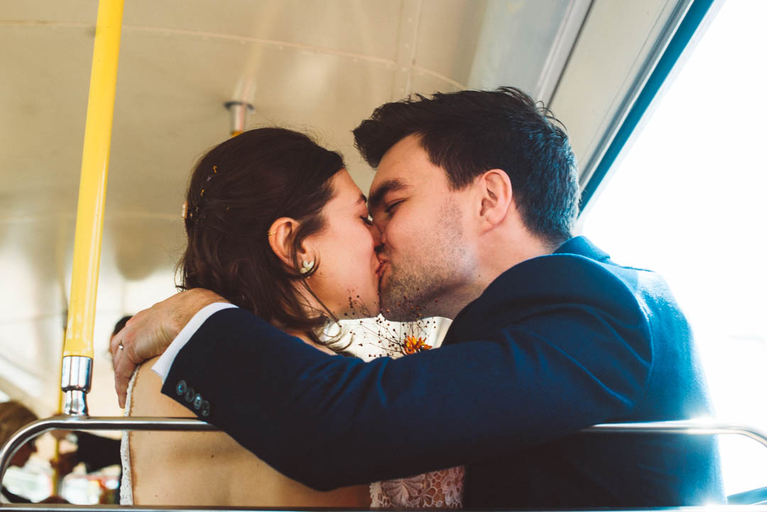 couple kissing on London wedding routemaster
