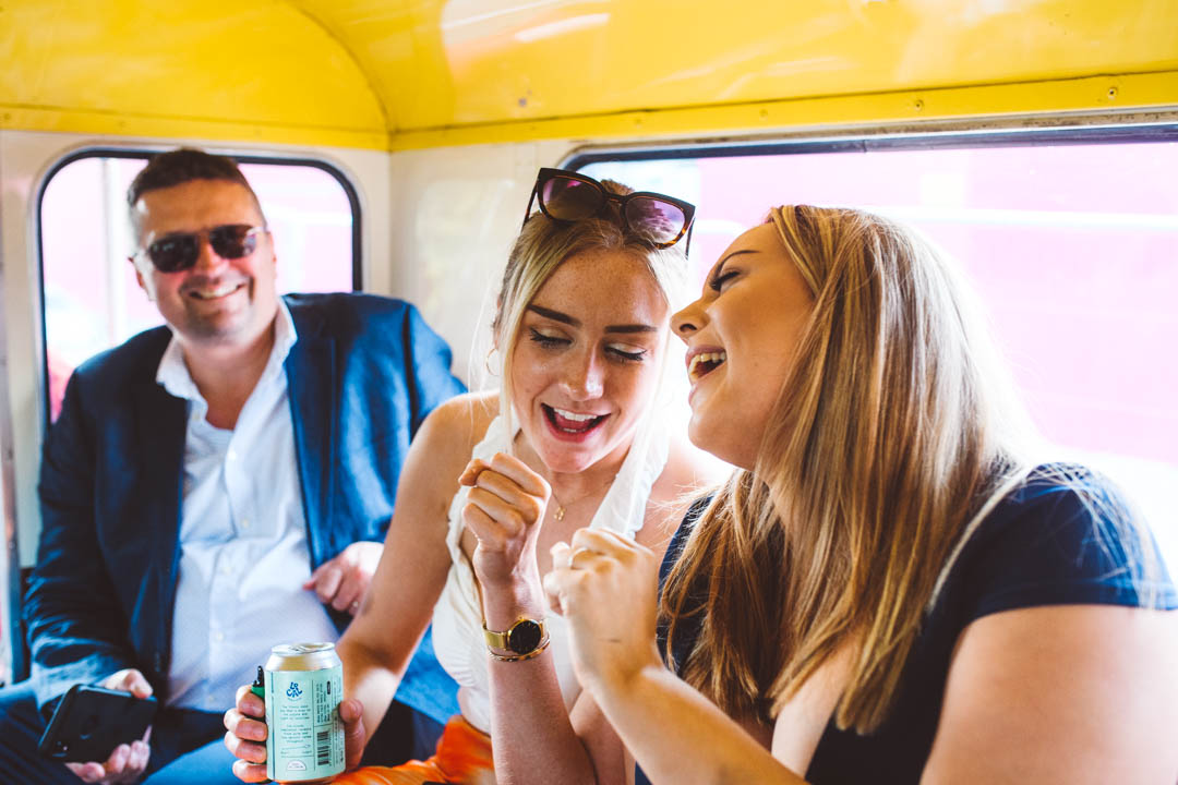 guests singing onboard vintage wedding bus