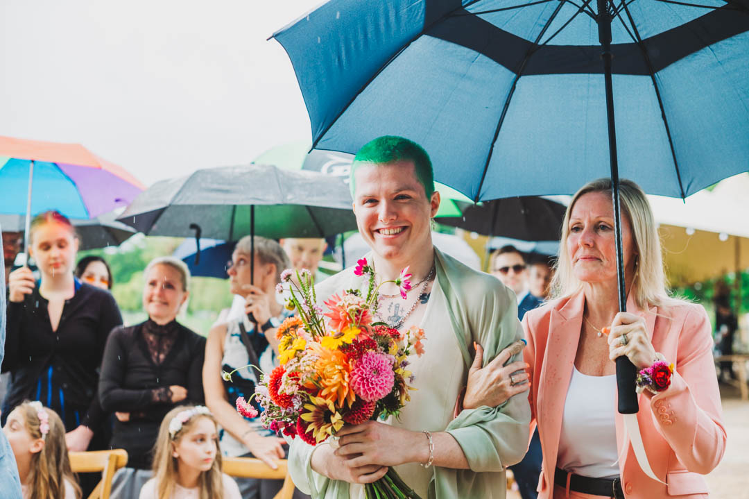 bride walking down the aisle with mother