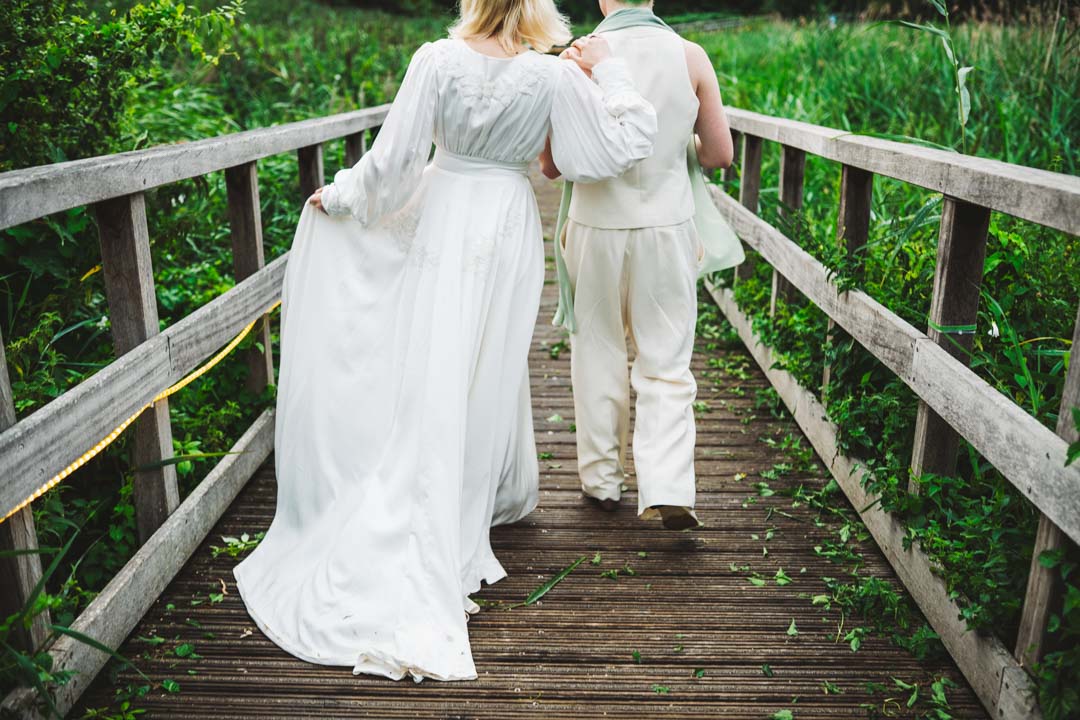 Woodberry Wetlands wedding couple walking on boardwalk