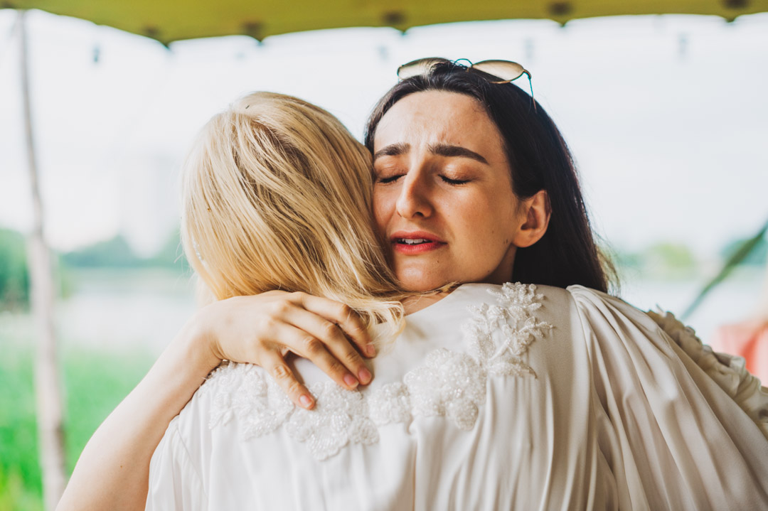 friend hugging bride